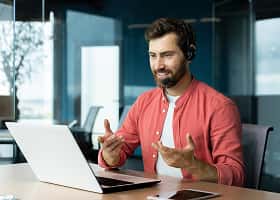 Voice actor recording dialogue at a laptop