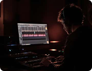 Audio engineer reviewing source material at a workstation