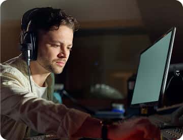 Reviewer wearing headphones checking localized voice output