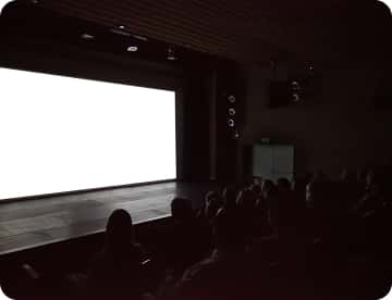 Audience watching a final mastered media presentation